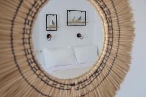 a mirror with a bed in a room at Giorgantis Studio II in Plaka Milou +30 photos