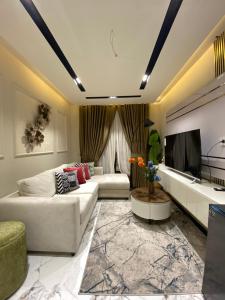 a living room with two couches and a tv at Sky square murree in Murree
