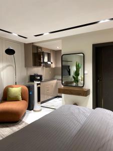 a bedroom with a bed and a tv and a chair at Sky square murree in Murree
