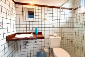 a bathroom with a toilet and a sink at Pousada Fruto do Mar in Ilhabela +30 photos