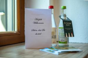 a bottle of wine and a paper bag with two bottles of wine at Gästehaus Wolfgang Taubensee in Ruhpolding +14 photos