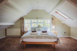 a bedroom with a large bed in a attic at Plasbach Cottage in Llandeilo