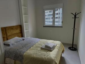 a bedroom with a bed with two towels on it at Sea view Appartment in Shëngjin