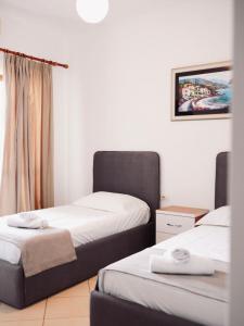 a room with two beds and a window at Corner Hotel in Ksamil +45 photos