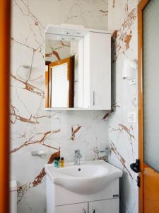 a bathroom with a sink and a mirror at Corner Hotel in Ksamil