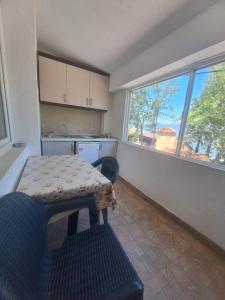 a small kitchen with a table and a window at Apartment Chukov in Star Dojran