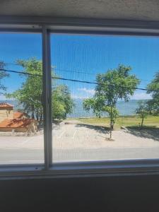 a window view of a street with a tree at Apartment Chukov in Star Dojran
