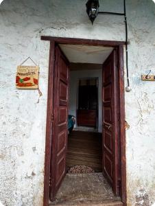 an open door of a building with a sign on it at Tarmeñita VIP in Tarma