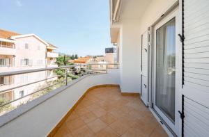 a balcony with a view of a building at Aurea Tivat Apartment in Tivat