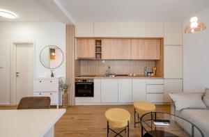 a kitchen and living room with a couch and a table at Aurea Tivat Apartment in Tivat