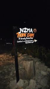 a sign for a hong kong sign in the dark at Nima homestay in Dirang Dzong