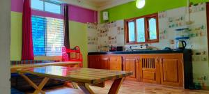 a kitchen with a table and a sink and a table at Nima homestay in Dirang Dzong