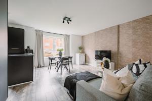 a living room with a couch and a table at SmartSleep Apartments in Glasgow