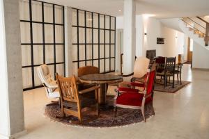a room with a table and chairs in a room at Hotel Lethehof in Wardenburg