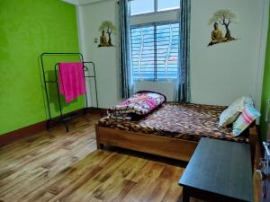 a bedroom with a bed in a room with a window at Nima homestay in Dirang Dzong
