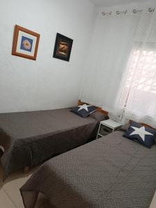 a room with two beds and a window at Ca la Nuri Pis 3 in Llança