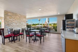 a restaurant with a table and chairs and a counter at Baymont by Wyndham Socorro in Socorro