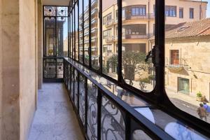 a balcony with a view of a building at Las villas de Manuel in Salamanca