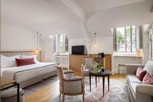 a bedroom with a bed and a living room at Hôtel & Spa de La Bretesche in Missillac