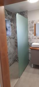 a bathroom with a glass door and a sink at casa2sonhos in Água de Pena +24 photos