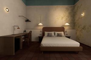 a bedroom with a bed and a desk and a desk at BYPILLOW Del Presto in Florence