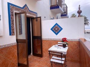 a room with a table and a door with a table and chairs at Guadalupe Hostal By Torremolinos On-line in Torremolinos
