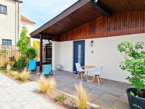 an outdoor patio with chairs and a table at ARGENTA Living 42 in Künzell