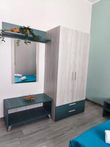 a bedroom with a cabinet and a mirror at B&B Casa Lina in Sarroch +27 photos