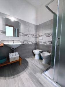 a bathroom with a sink and a toilet and a shower at B&B Casa Lina in Sarroch