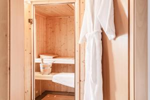 a wooden sauna with a towel hanging on a wall at Chalet Hinter dem Rot Stei, private wellness, in ski and hiking area of Zermatt in Zermatt