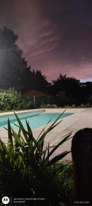 a close up of a swimming pool next to a beach at Complejo Bellotas in Agua de Oro
