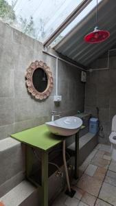 a bathroom with a sink and a mirror on the wall at Finding Clover in Banjār +23 photos