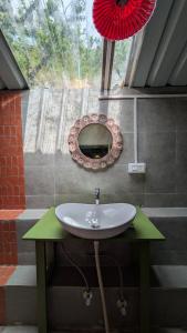 a bathroom with a sink and a mirror on the wall at Finding Clover in Banjār