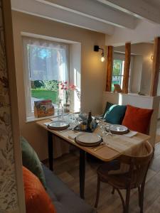 a dining room table with plates on top of it at La Maison d'André in Digny
