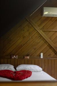a bed with two pillows in a room with a wooden ceiling at Recanto Deucher in Imaruí +15 photos