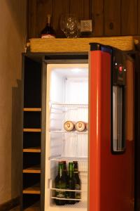 an open refrigerator filled with lots of beer bottles at Recanto Deucher in Imaruí