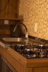 a stove top with four burners on top of it at Recanto Deucher in Imaruí