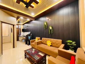 a living room with a couch and a table at Ophelia in Agra