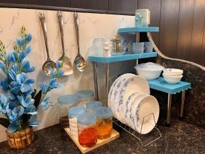 a shelf with jars and utensils on a counter at Ophelia in Agra