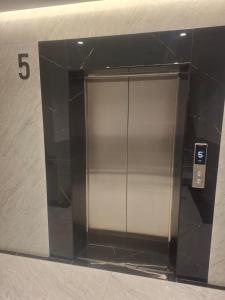 an elevator in a building with the number at Enea Apartments 9 in Tirana