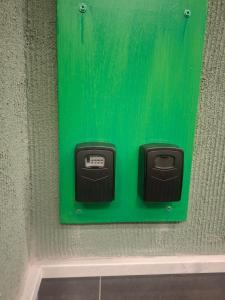 a green box on the side of a wall at Enea Apartments 9 in Tirana