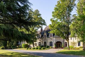 a large stone house with a driveway at Hôtel & Spa de La Bretesche in Missillac