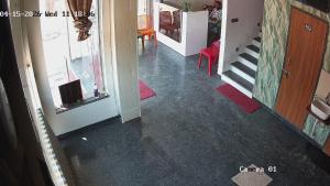 a hallway with a staircase and a room with a flooring at Om Dayama Please in Khātu