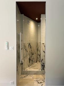 a bathroom with a shower with a marble tile wall at Cozy Studio, Pool & Beaches 2 min away in Roquebrune-Cap-Martin +22 photos