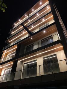a tall building with lights on the side of it at Sky square murree in Murree