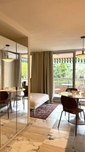 a bedroom with a bed and a table and a mirror at Cozy Studio, Pool & Beaches 2 min away in Roquebrune-Cap-Martin