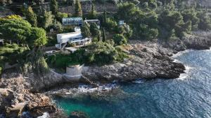 an aerial view of a house next to the water at Cozy Studio, Pool & Beaches 2 min away in Roquebrune-Cap-Martin