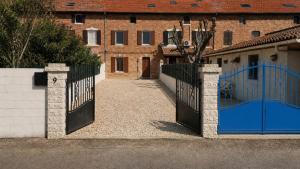 a pair of gates in front of a building at L'oiseau bleu in Salin-de-Giraud