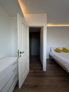 a white bedroom with a bed and a closet at Zenith Cairo Deluxe Room Shared Apartment in Cairo