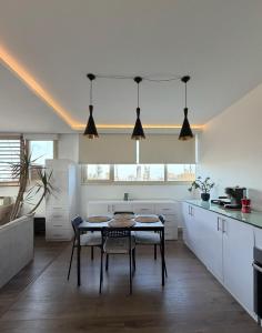 a kitchen with a table and chairs in a room at Zenith Cairo Deluxe Room Shared Apartment in Cairo